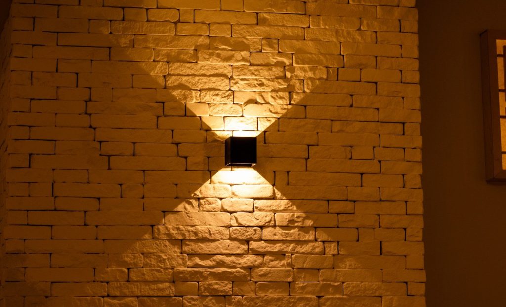 a brick wall with a light shining on it