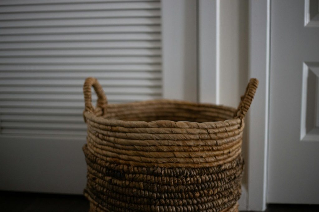 a basket sitting on the floor next to a door