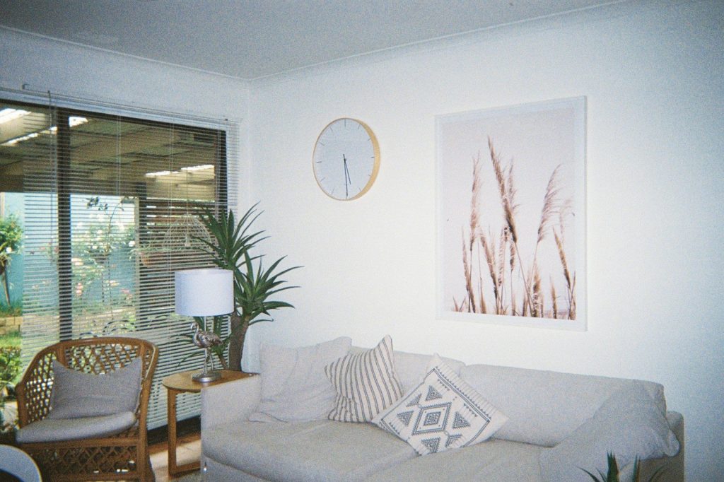 a living room filled with furniture and a clock on the wall