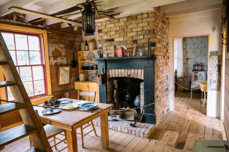 a living room with a fire place and a ladder