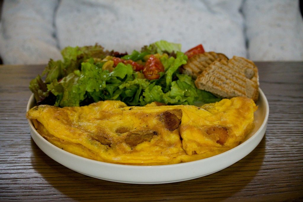 Omelette with salad and toast served on a plate