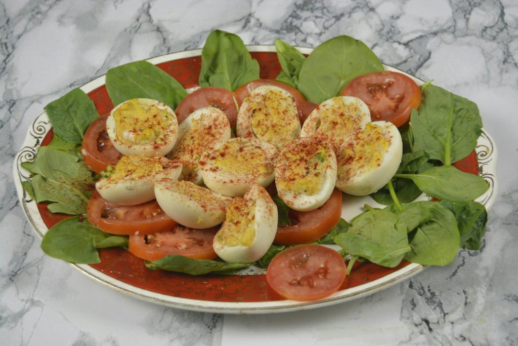 salted egg on top of sliced tomatoes
