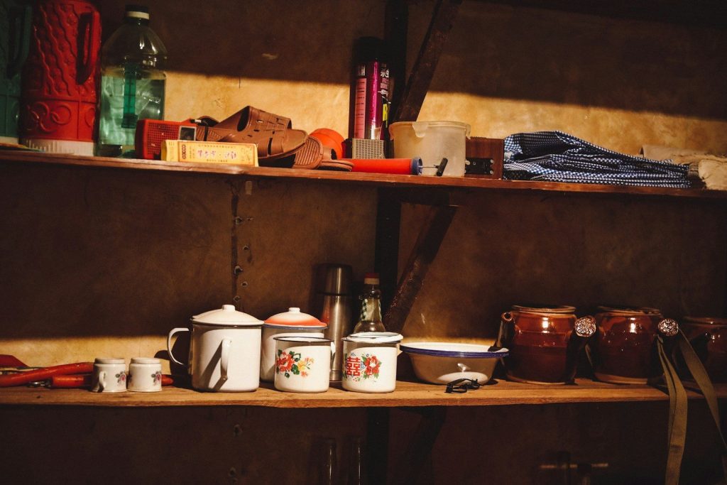white ceramic cup on brown wooden shelf