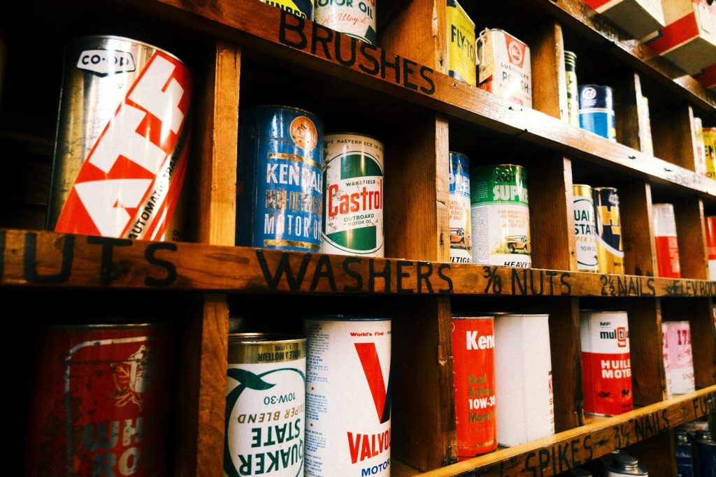 Shelves stocked with vintage cans of paint and hardware.