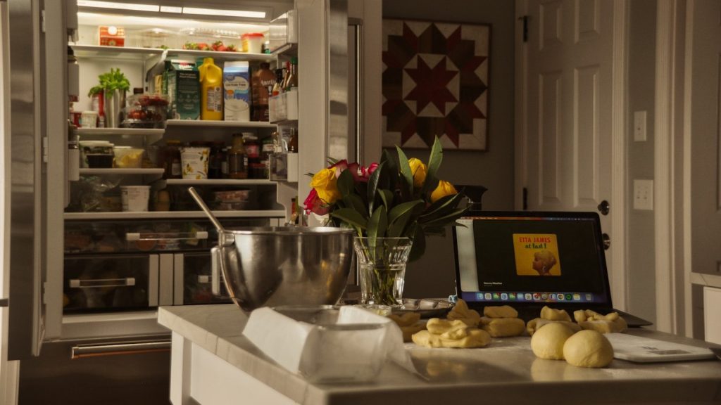 Kitchen counter with baking ingredients and open pantry