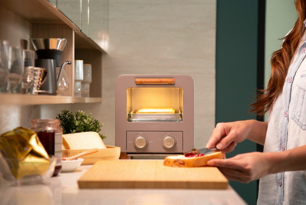 a woman cutting a pizza