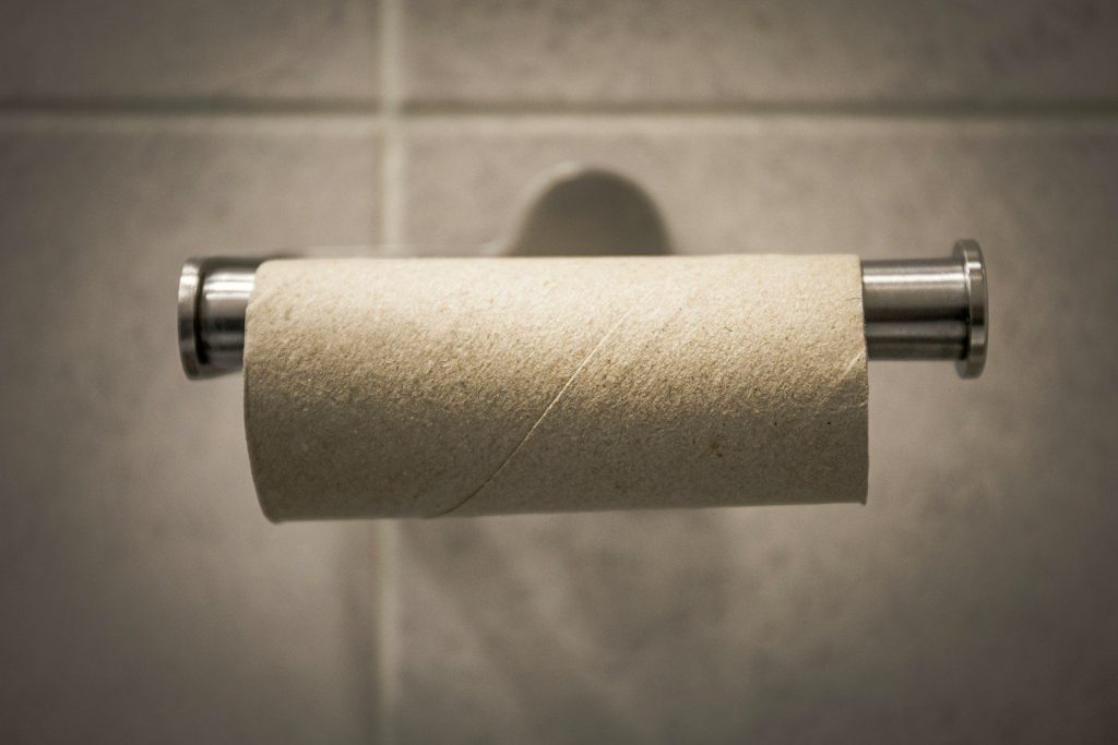 white toilet paper roll on stainless steel toilet paper holder