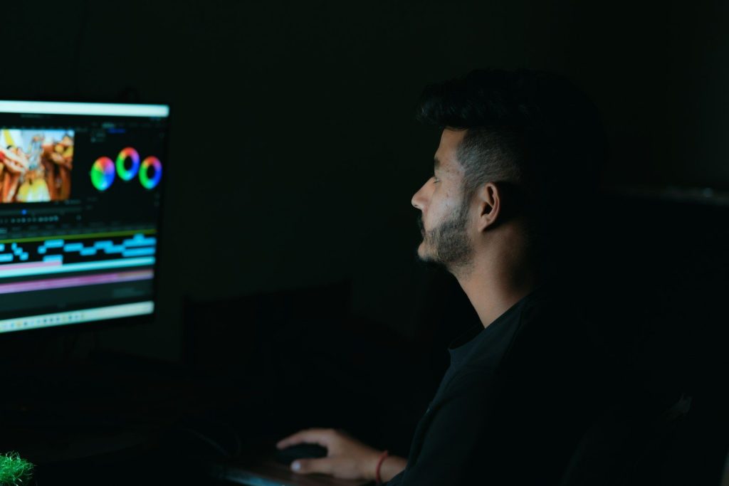 a man sitting in front of a computer screen