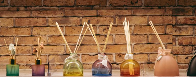 A row of bottles with sticks sticking out of them