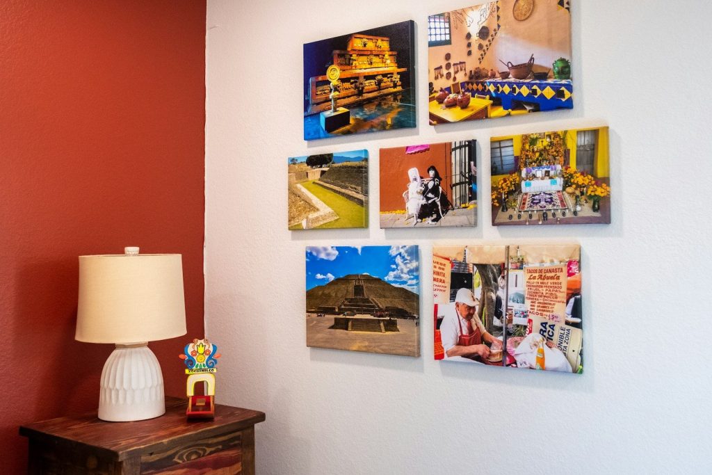 a wall with a lamp and pictures on it