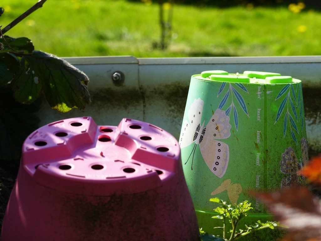 Two upside down plant pots in a garden.