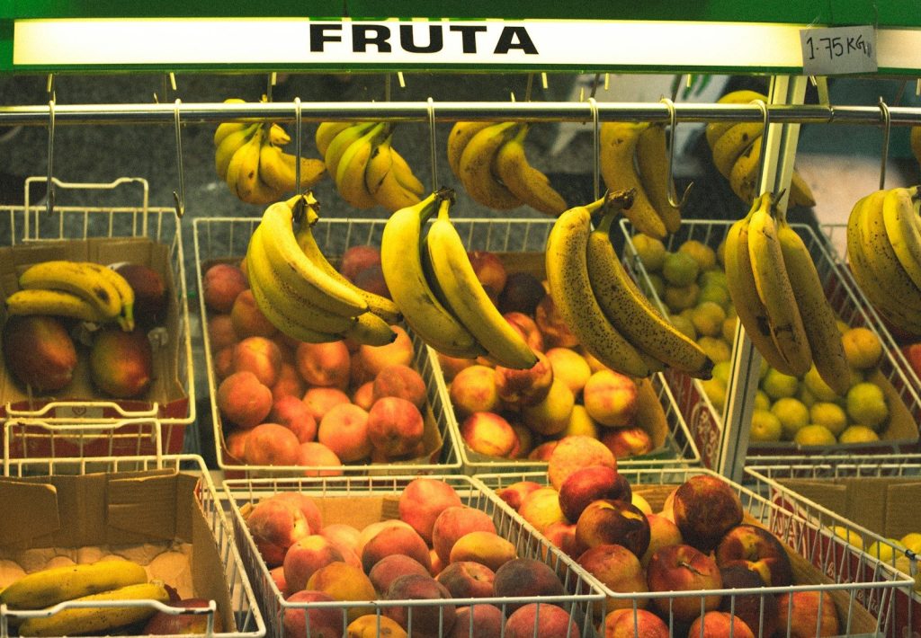 A fruit stand with a variety of fruits in baskets