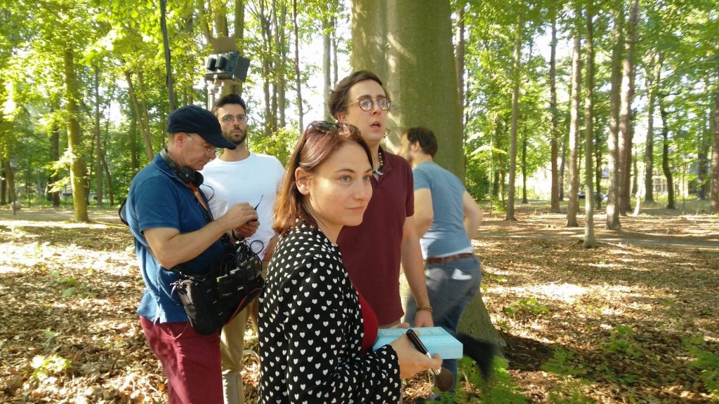 a group of people standing next to each other in a forest