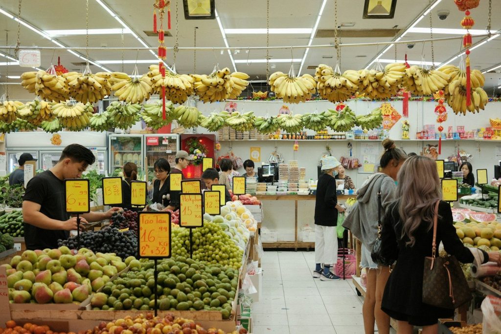 People shop for produce in a vibrant market.