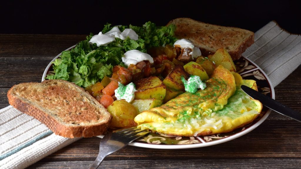 Delicious breakfast plate with toast and greens.