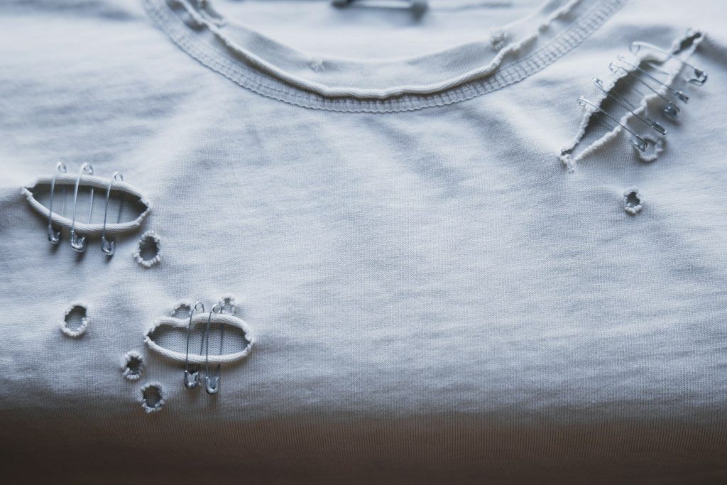 A ripped white t-shirt is shown.