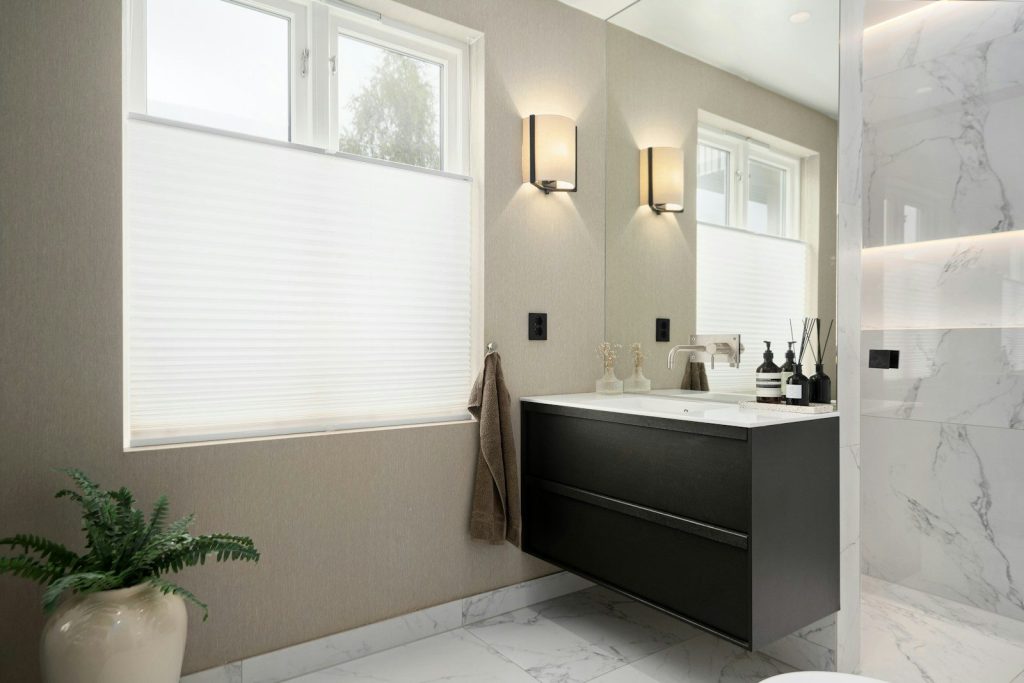 A bathroom with a toilet, sink, and shower