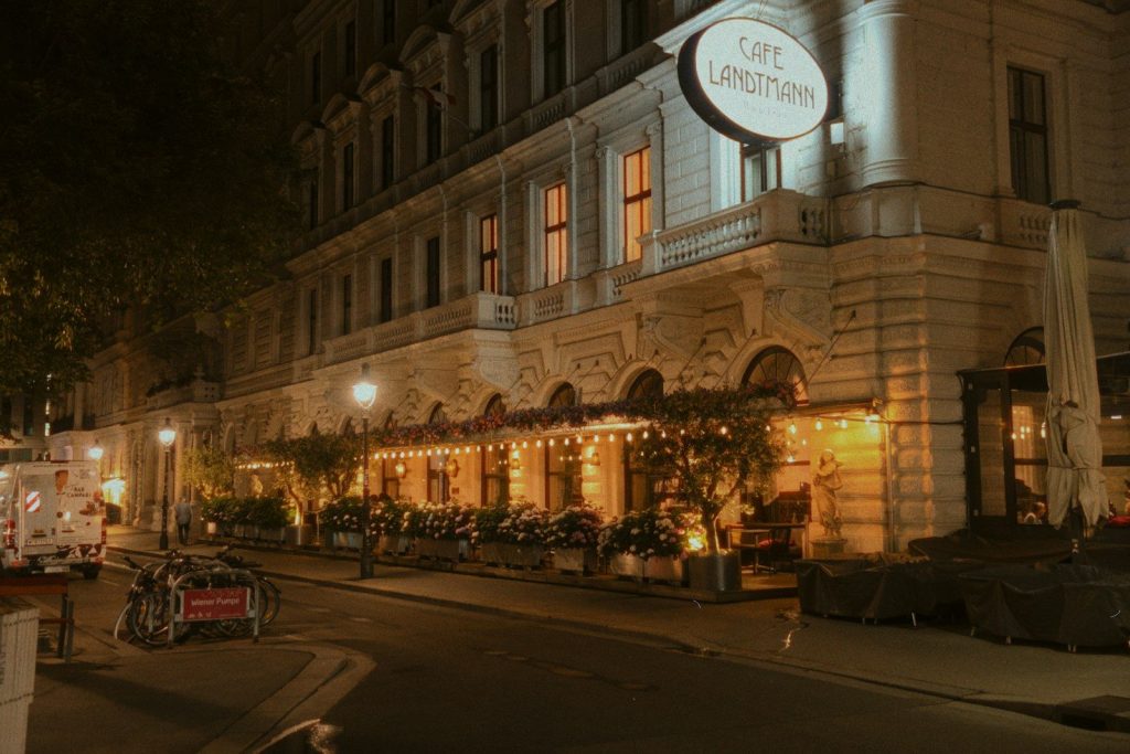 Cafe landtmann building illuminated at night.