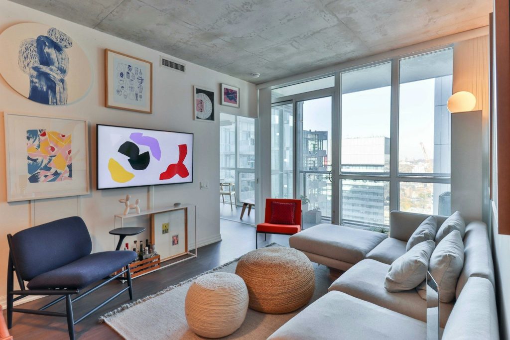 a living room filled with furniture and a flat screen tv