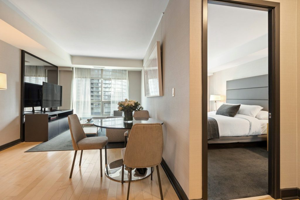 brown wooden chair beside white bed