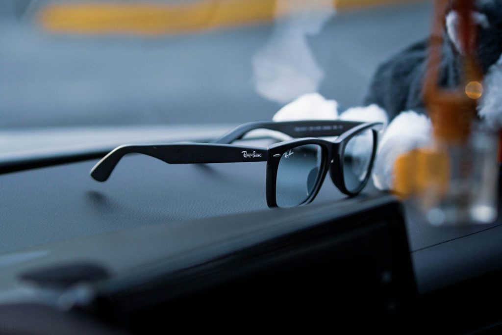 Black ray-ban sunglasses resting on a dark surface.