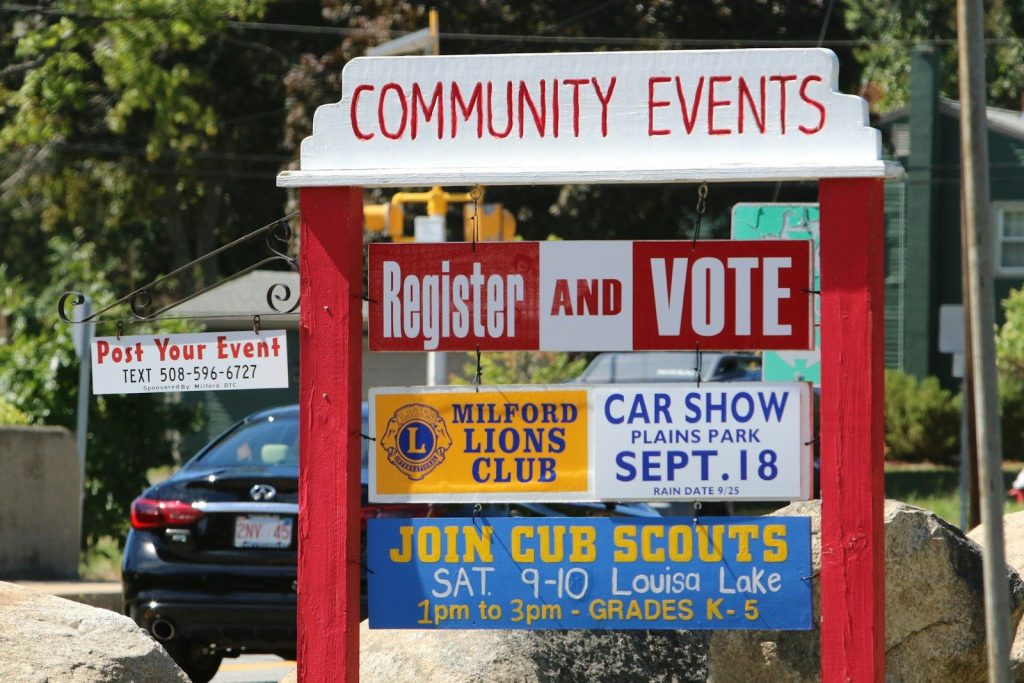 a red sign with a bunch of political signs on it