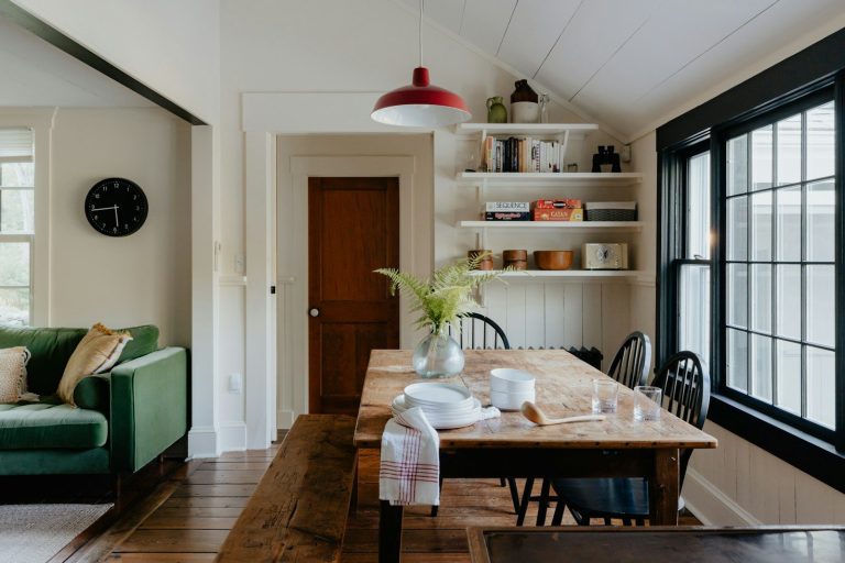 A living room and dining room with a couch and a table