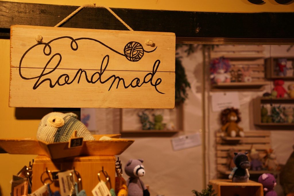 Wooden sign with "handmade" written on it.