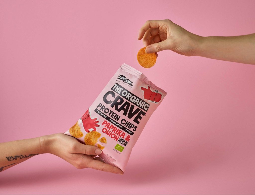 a person is holding a bag of crave crackers