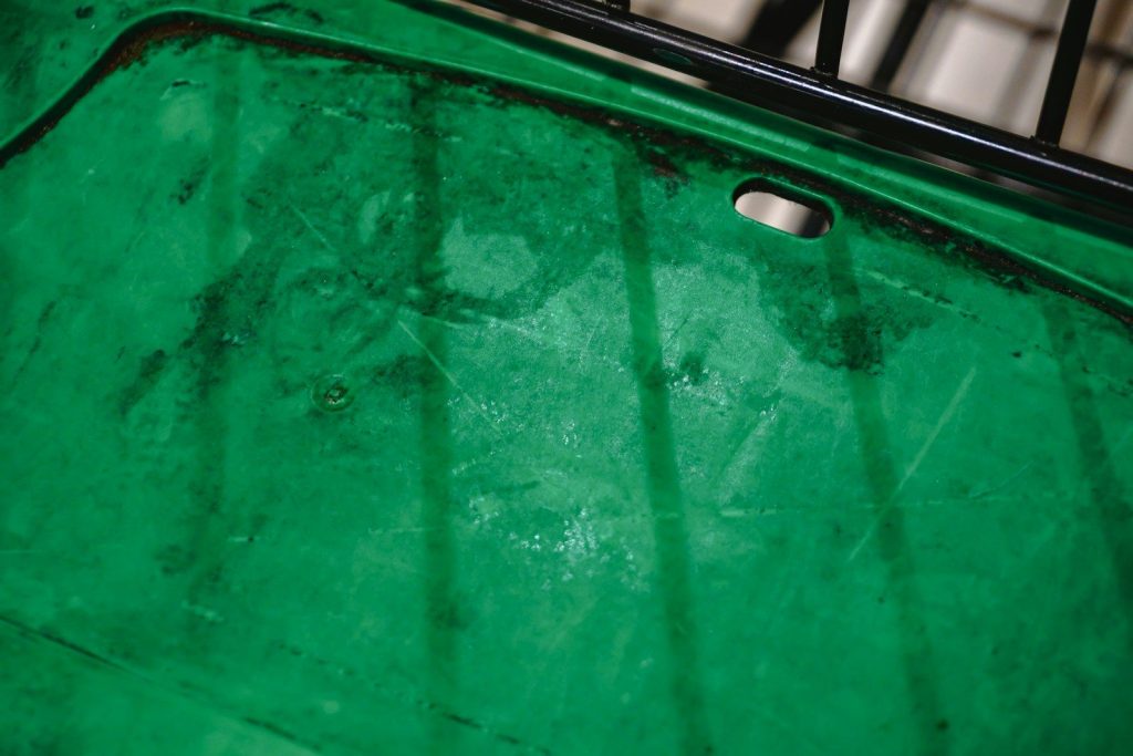 A close-up abstract view of a weathered green surface.