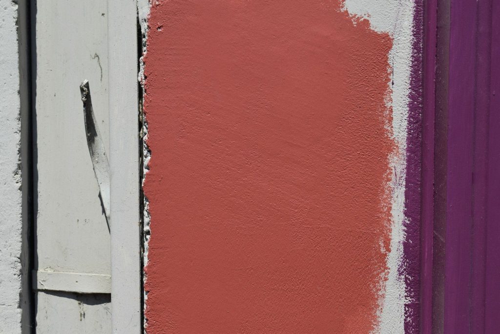 Three colors of painted wood form a pattern.