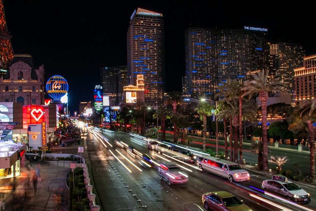 Vibrant cityscape with car light trails at night.