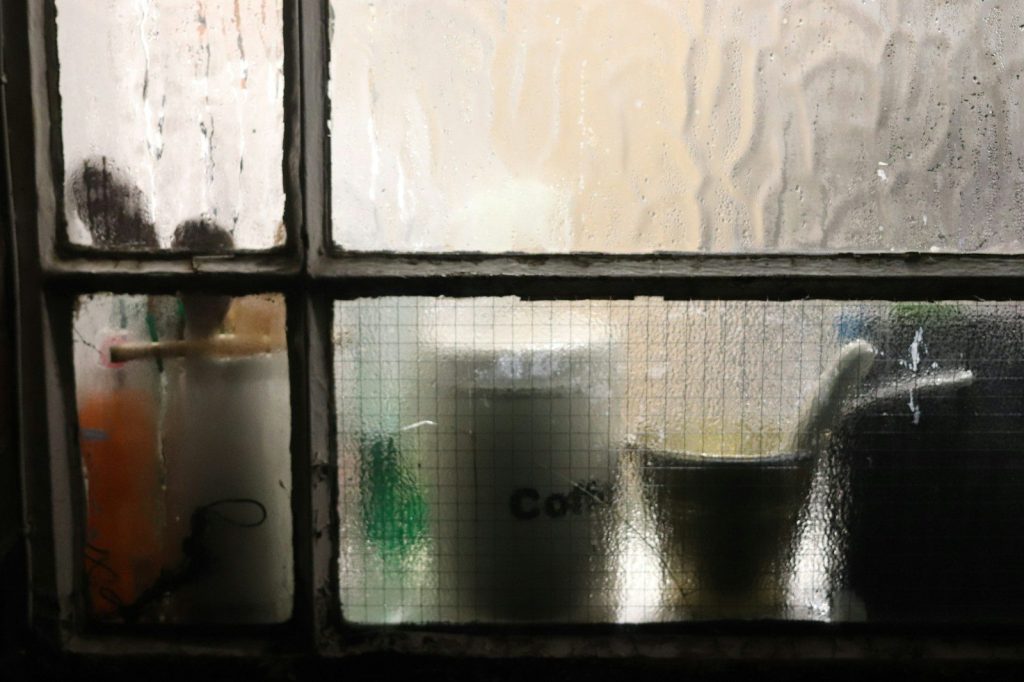 Mug and container seen through frosted glass