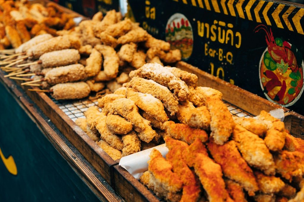 Delicious, deep-fried food is displayed for sale.