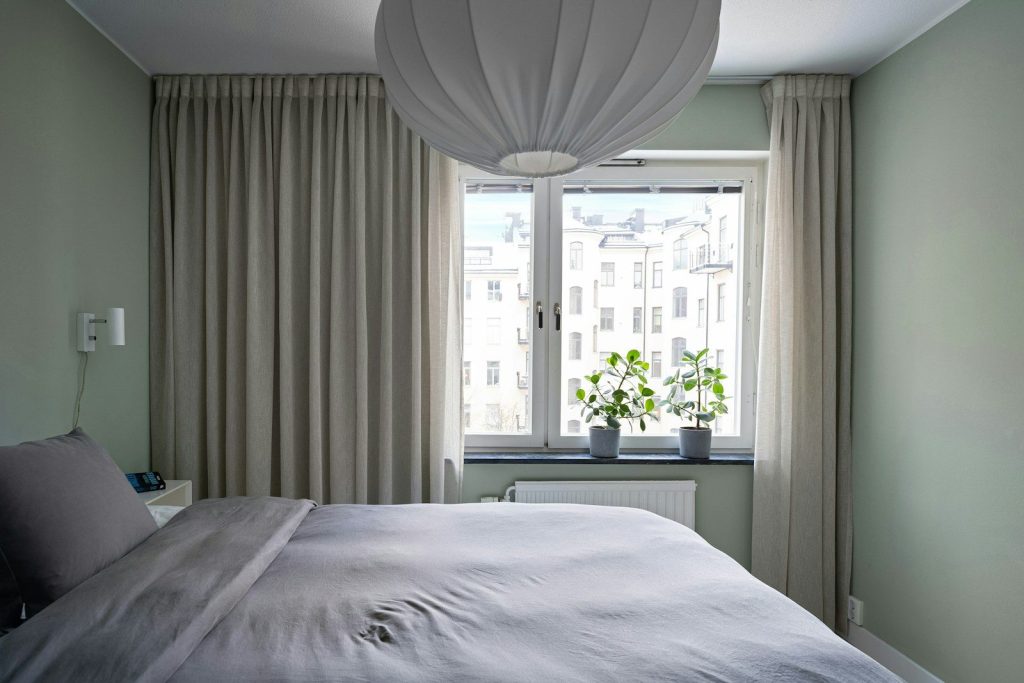 A bedroom with a large bed and a window