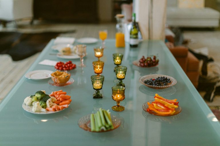 A table set with appetizers and candles for a gathering.