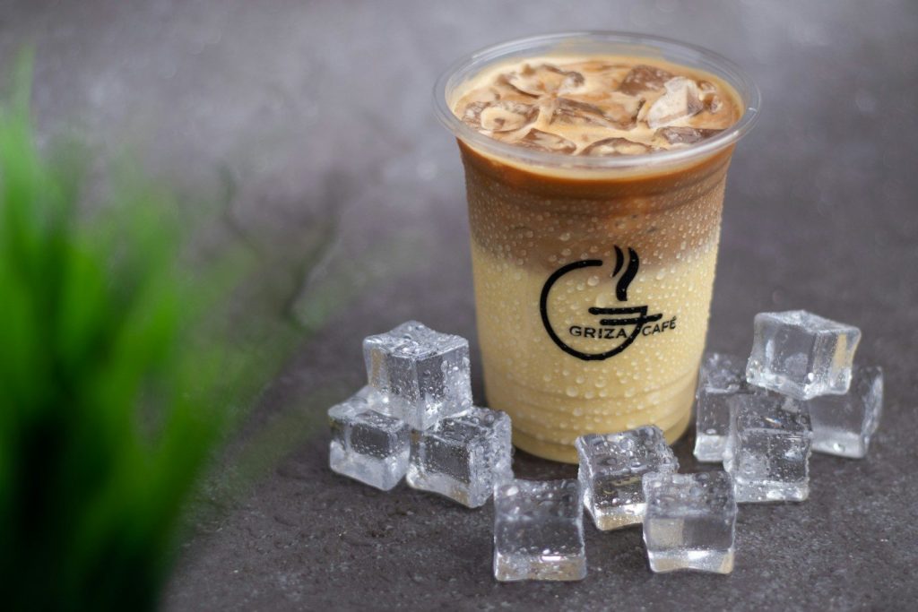 a cup of iced coffee surrounded by ice cubes