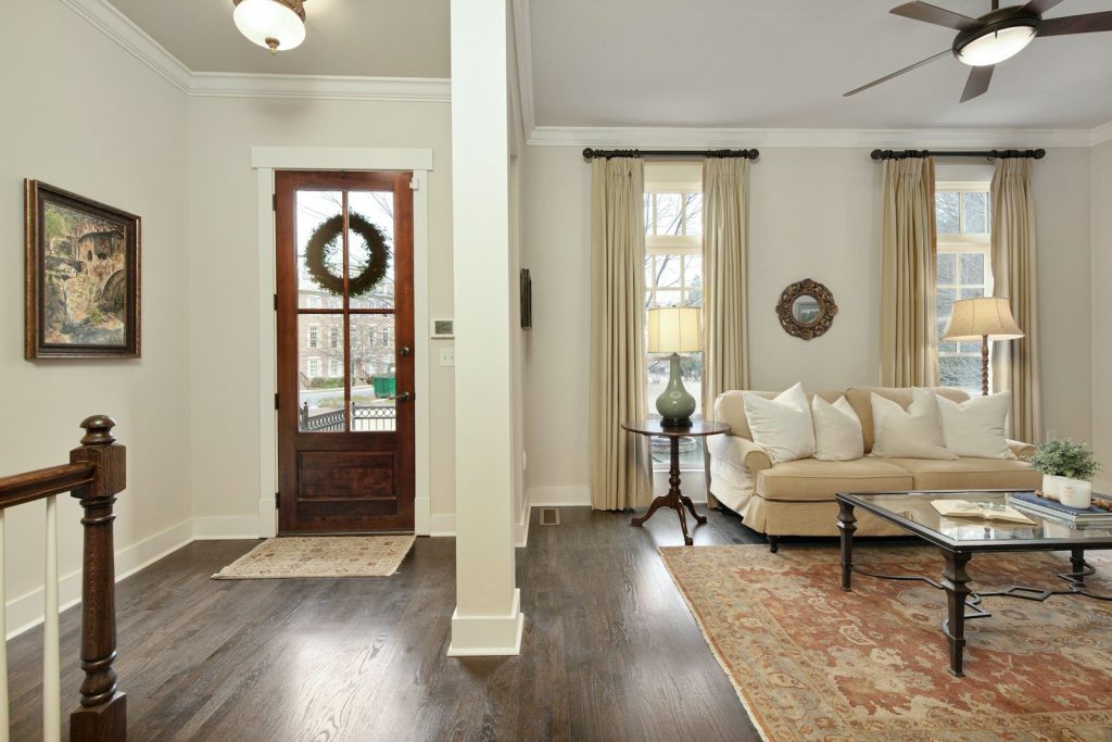A living room filled with furniture and a ceiling fan