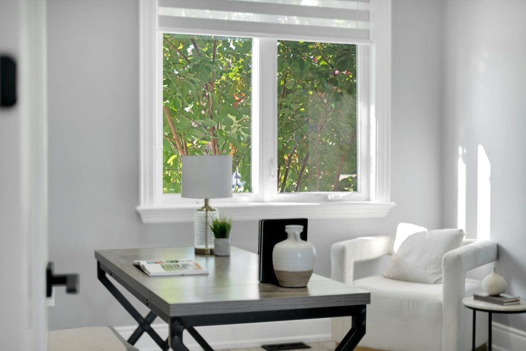 Bright home office with desk, chair, and window.