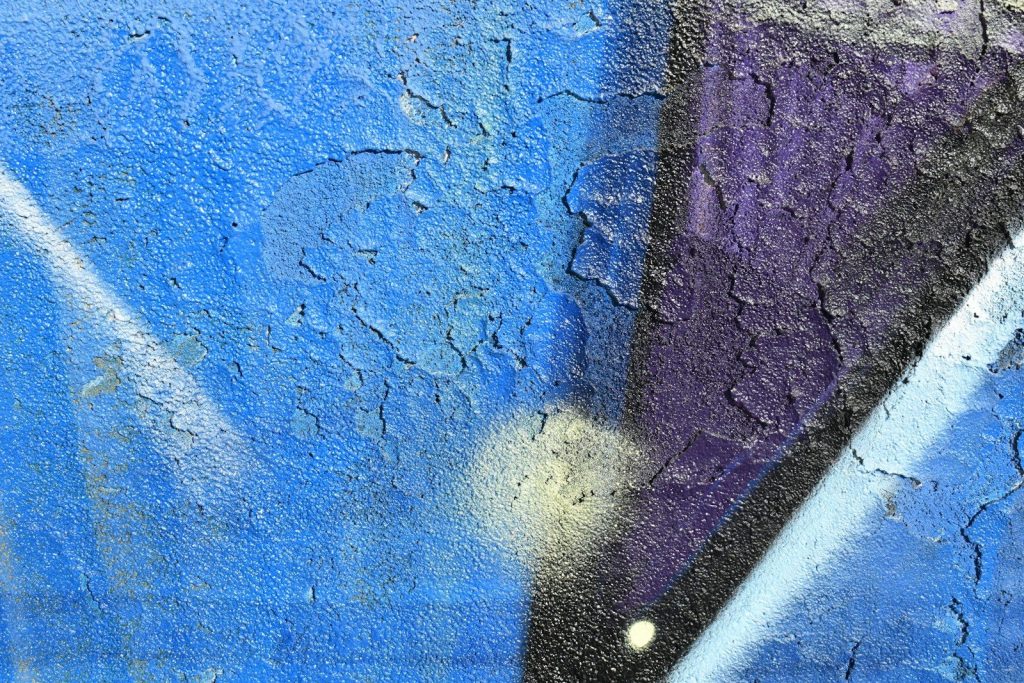 a close up of a blue and purple wall