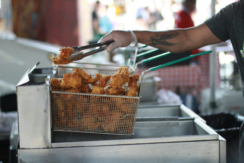 shallow focus photo of person holding tongs