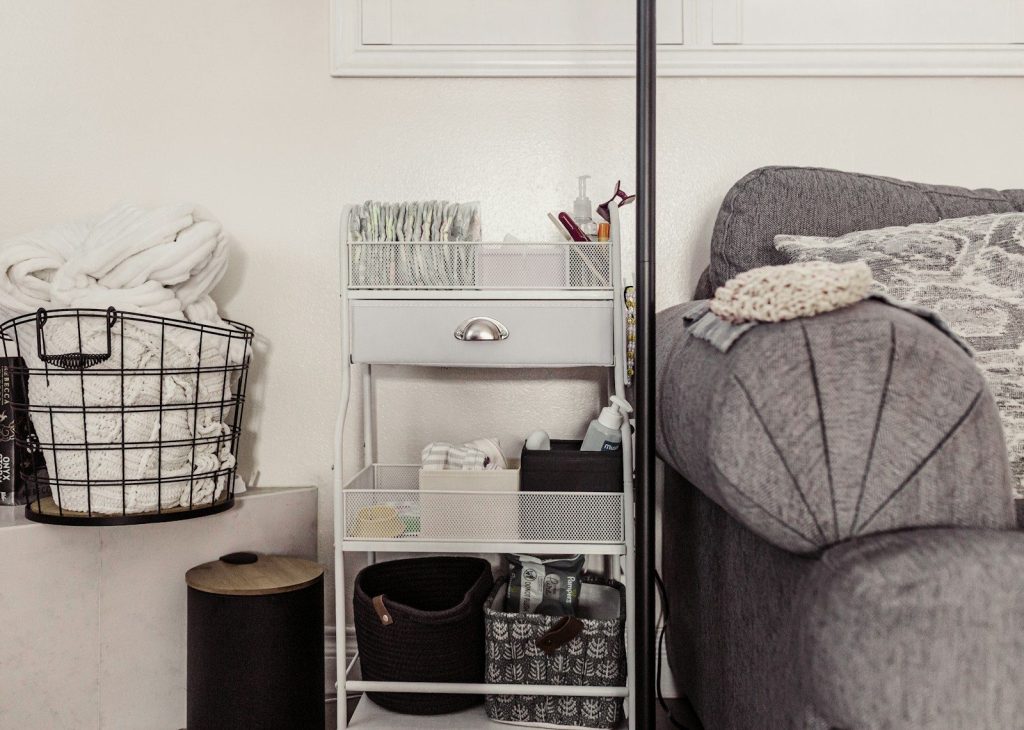 Storage cart with baskets next to sofa