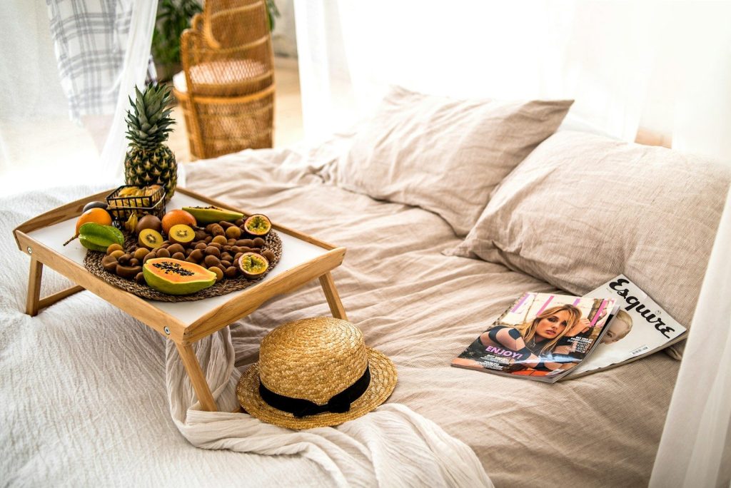 brown wooden tray with cupcakes on white textile