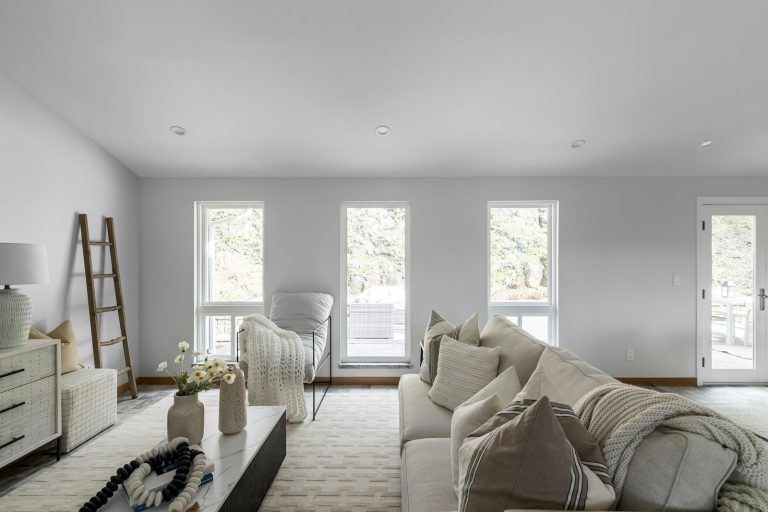 A living room filled with furniture and lots of windows