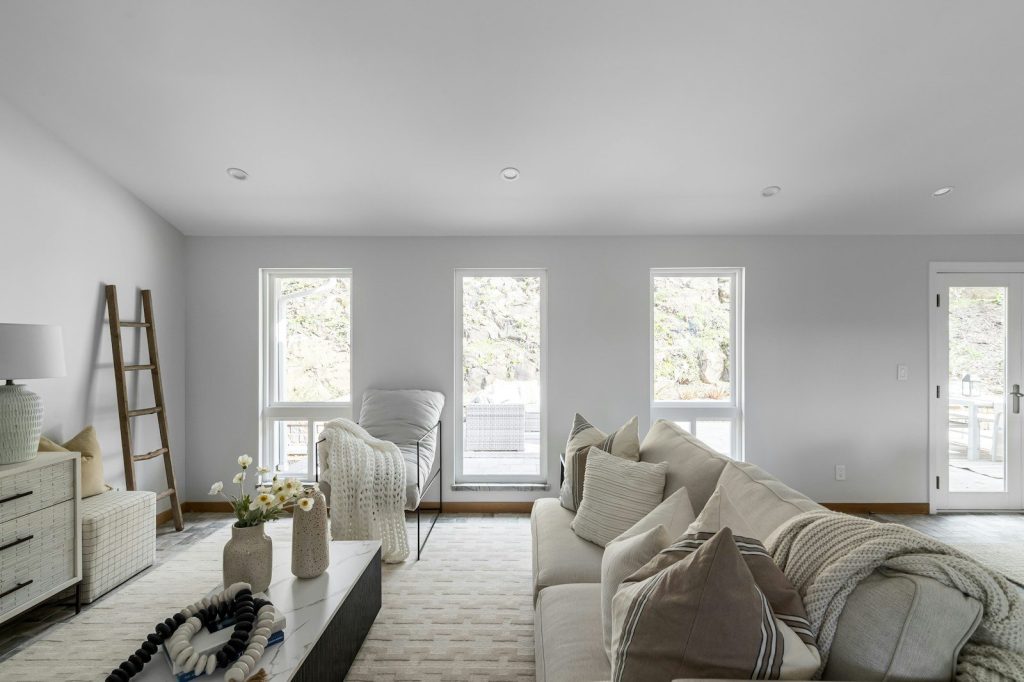 A living room filled with furniture and lots of windows