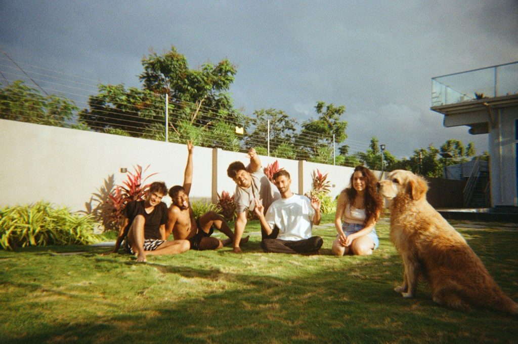 Family and dog posing for a picture outdoors