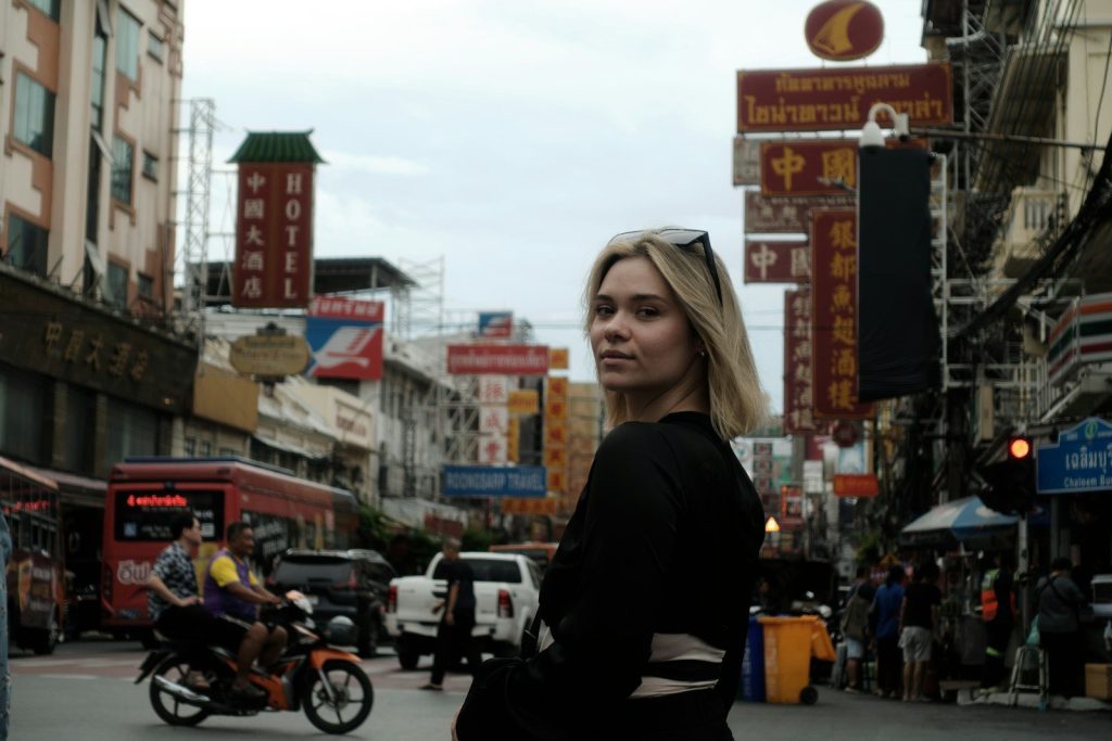 Woman in a busy street with signs
