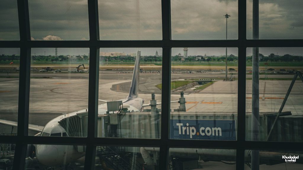 Plane at the airport, viewed through a window.