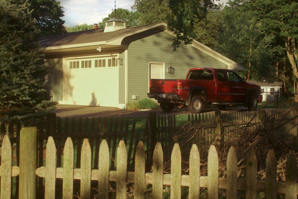 a red truck parked in front of a house