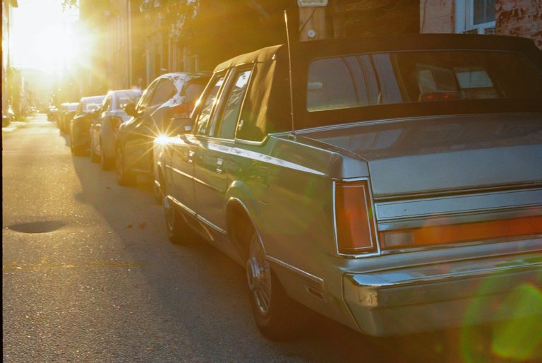 A row of parked cars on a city street